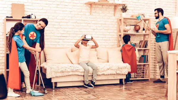 Superheroes Family Looking Kid Playing VR Headset. Virtual Journey. Future Technology Concept. Girl Using Virtual Reality Glasses. Happy Family with Children and Parents Having Fun with VR.