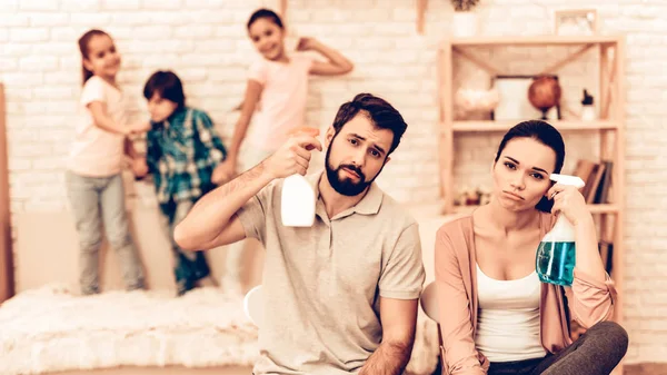 Portrait of Tired Parents After Cleaning Home. Cleaning Day Concept. Kids Helping House Chores. Parent Concept. Domestic Concept. Togetherness Cleaning. Mom and Dad Want to Die after Hard Day.