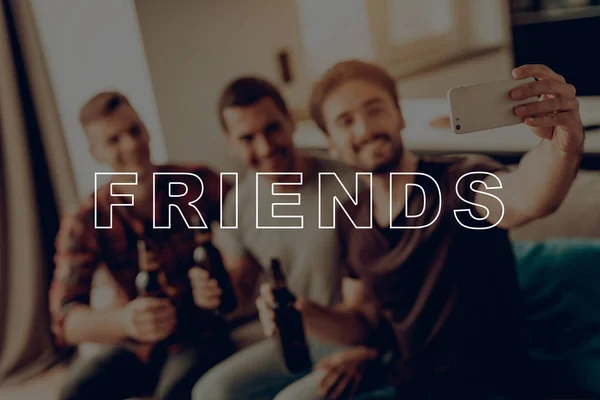 Men Having Fun. Friends Smiling and Posing for Selfie. Friends Sit on Couch. Three Men Drink Beer. Guys Hold Dark Bottles. Cheerful Best Friend Forever. Guys Happy Together. Men Spend Time Together.