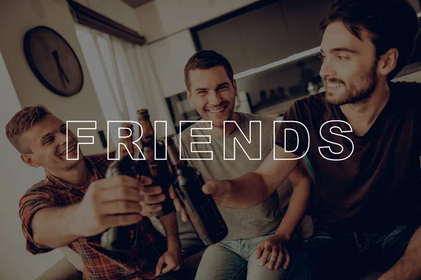Three Men Drink Beer. Guys Hold Dark Bottles. Cheerful Best Friend Forever. Friends Sit on Couch. Men Having Fun. Friends Smiling and Posing for Photo. Guys Happy Together. Men Spend Time Together.