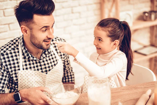Cook Food at Home. Happy Family. Father\'s Day. Girl and Man Cooking. Man with Flour on Face. Spend Time Together. Food on Table. Break Egg in Bowl. Pour Flour. Cook Dough. Pour Flour in Bowl.