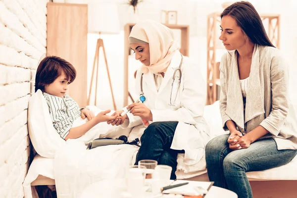 Arabic Doctor Measuring Blood Sugar Level Boy. Child at the Pediatrician. Hospital Concept. Healthy Concept. Child Patient Visiting Doctor. Doctor Checking Blood Sugar Level.