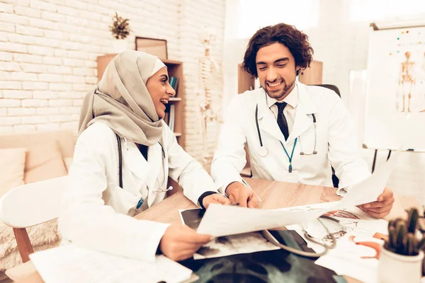 Medical Consultation Arabic Pediatricians Doctors. Muslim Doctors Having Consultation in Office. Arabic Doctors Holding X-Ray, Medical Consultation. Hospital Concept. Healthy Concept.