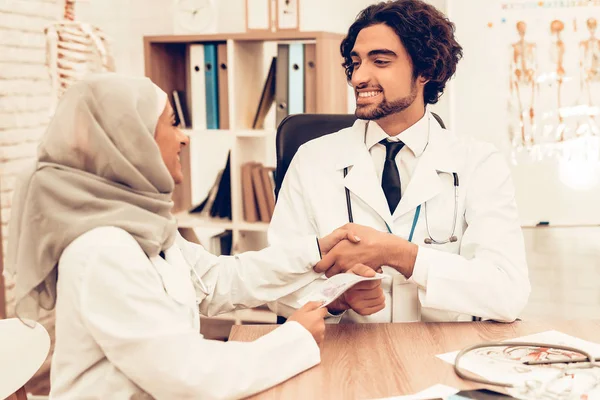 Arabic Doctors Counting Money After Work, Payday. Muslim Doctors Counting Dollars in Office. Arabic Doctors Holding Money, Medical Consultation. Hospital Concept. Healthy Concept. Healthcare