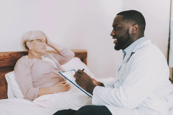Woman Tell about her Condition. Doctor Fills Form. Doctor Examines Elderly Patient. Patient Have Headaches. Patient Feel Sick. Doctor Interviews Woman. Woman Lay in Bed. Nursing Home. Man with Papers.