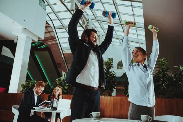 Corporate Sport Lifestyle. Healthcare of Business People. Office Workers Working with Dumbbells. Workers doing Fitness Exercises. Yoga Practice. Employee Man Smiling to Healthy Woman.