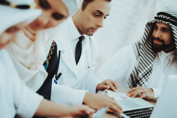 Arabic Family Patient Giving Money to Doctor.. Confident Muslim Female Doctor. Child at the Pediatrician. Hospital Concept. Healthy Concept. Family Visiting Doctor. Reception of Therapist.