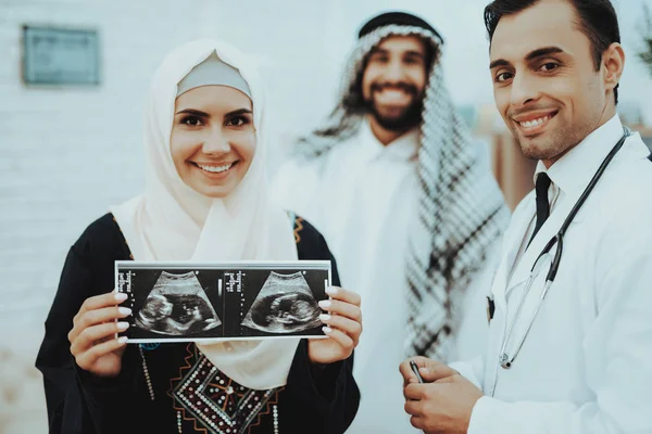 Happy Pregnancy Muslim Woman Hold Ultrasound Image. Doctor Holding Ultrasound Image. Pregnancy Woman. Gynecologist Concept. Motherhood. Arabic Woman Wearing Hijab in Hospital. Ultrasound Concept.