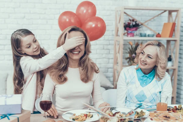 Family Preparing Surprize for Mother at Home. Cake on Table. Happy Family. Mother with Daugther. Smiling Women. Smiling Grandmother. Celebration Concept. Glass of Wine. Closed Eyes. Red Bbaloons.