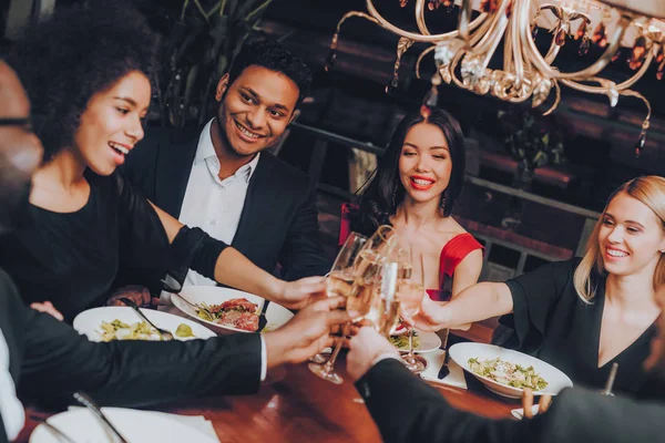 Group of Happy Friends Meeting and Having Dinner. Celebrating with Friends. Party Dinner Table. Enjoying Meal In Restaurant. Restaurant Chilling Out Classy Lifestyle Reserved Concept.