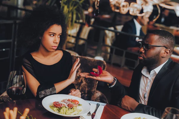 Man Proposing Engagement Ring and Getting Denied. Romantic African American Couple in Love Dating. Cutel Man and Girl in a Restaurant. Romantic Concept. Negative Reaction to Proposing.