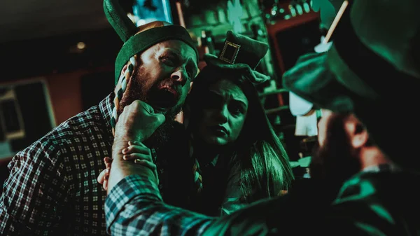 Two Men Fight In Pub. Saint Patrick\'s Day Concept. Punch In The Face. Quarrel In The Bar. Plaid Flannel. Agressive Males. Angry Guys. Violence In The Club. Knock Out. Bright Lights.