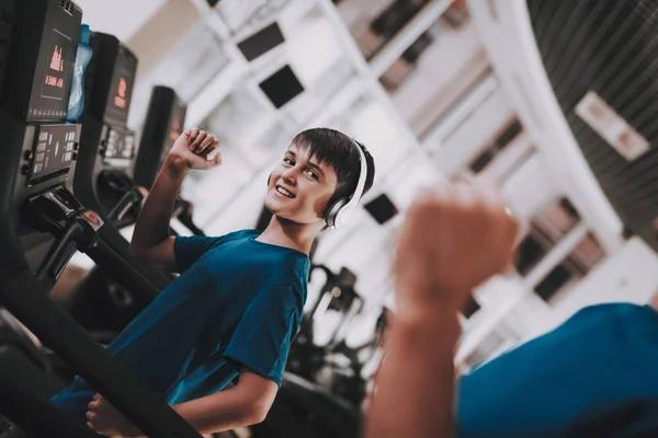 Jóvenes entrenamientos de padre e hijo en cintas de correr en el gimnasio — Foto de Stock