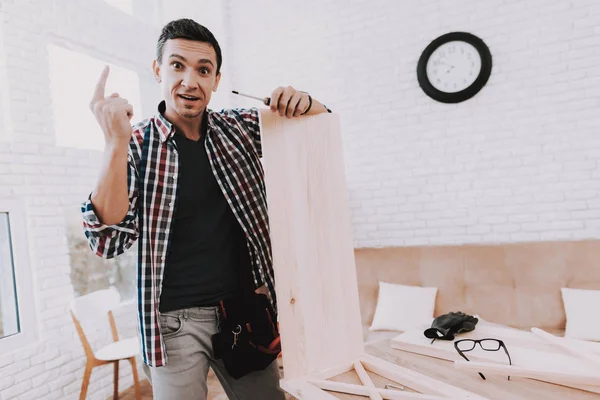 若い男自宅の組立木製本棚です 木製の本棚 自作の家具 男と趣味 白い部屋 ツール エンジニア 自宅の若い男 自家製の装飾 モダンな家具 — ストック写真