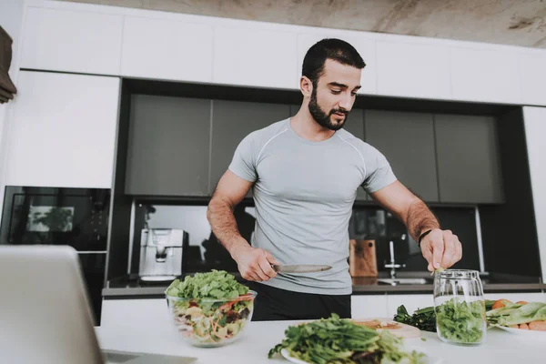 An Athletic Man Is Preparing Salad For Breakfast. Cooking Concept.. Healthy Lifestyle. Young And Handsome. Sport Body. House Interior. Dish Chopping. Morning Fresh Nutrition. Role Model.