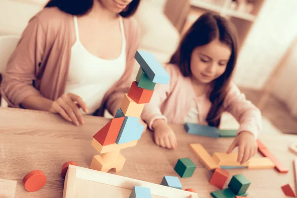 Mother Teaches Daughter Build House Cubes on Table — Stock Photo, Image