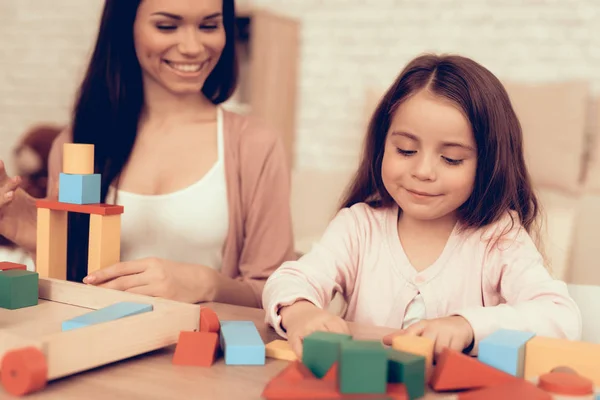 Smiling Woman and Girl with Colored Cubes in Hands — Stock Photo, Image