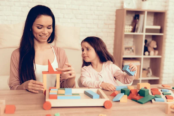 Mom and Daughter Geting Cubes out Box on Table. — Stock Photo, Image