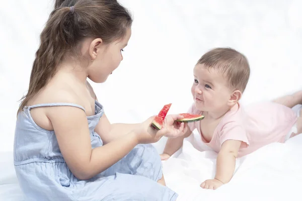 Children Eat Red Watermelon Girl Treats Baby Sisters Look Each — Stock Photo, Image