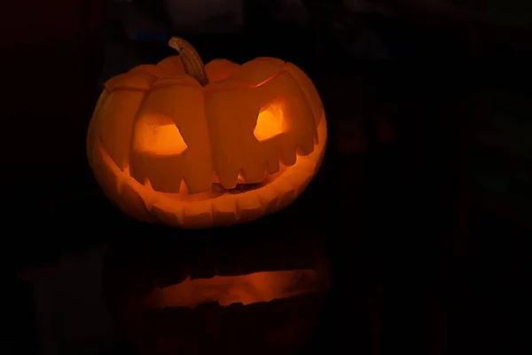 Halloween pumpkin Jack O lantern on black table background