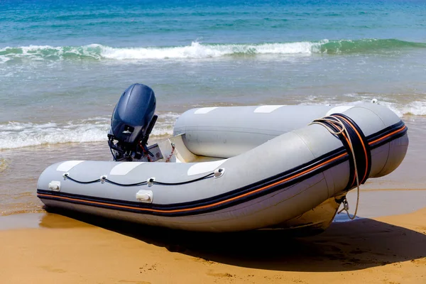 inflatable rubber boat on the seashore with motor
