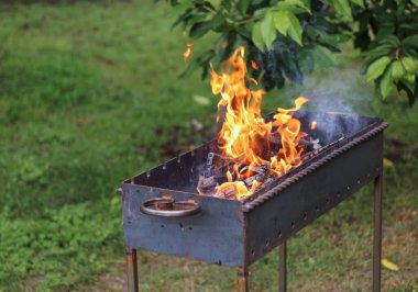 Barbeküde odun yakmak açık havada barbekü yapmak için.