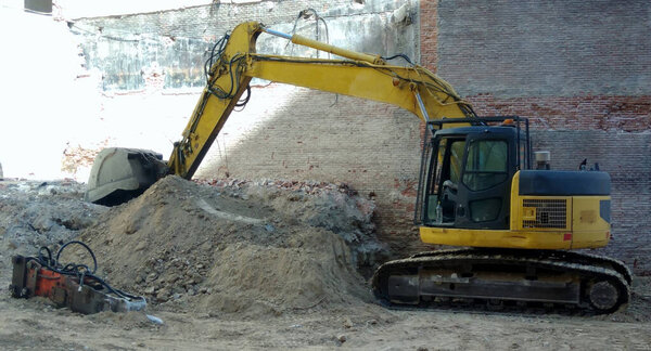 one construction excavator of yellow color on the construction site