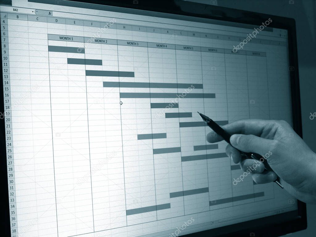 close up of engineer working on time chart diagram at computer, construction project gantt diagram