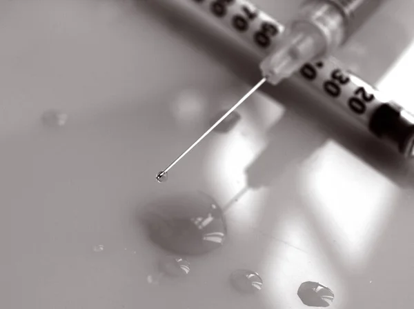 Antobiotics medication concept: close up of syringe\'s needle loaded with medication