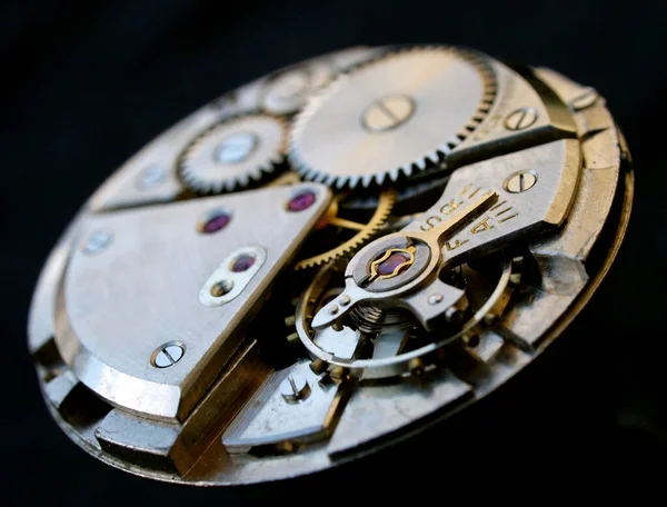 vintage watch mechanism macro detail over black background