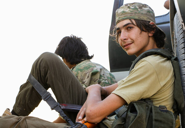 Aleppo, Syria 10 July 2017A child fighter supplies ammunition to his comrades