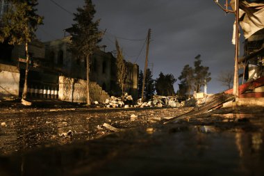 Night photo of the destruction of residential houses after the bombing. Aleppo, Syria 05 NOV 2017:  clipart
