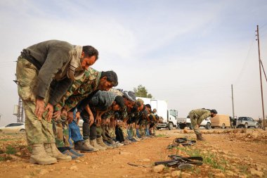 Aleppo, Syria 29 June 2017: Soldiers collectively pray in the army clipart
