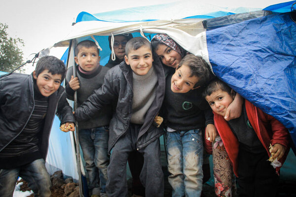 Aleppo, Syria 15 February 2017A group photo of refugee children in the camp after they left school amid snow.