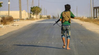 Halep, Suriye, 17 Nisan 2016: Ağır silah sesleri arasında koşan askerler