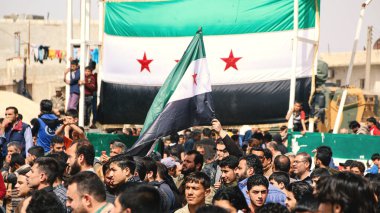 Aleppo, Syria October 18, 2018A demonstration bearing the flags of the Syrian revolution calls for an end to the bombing of Idlib. clipart