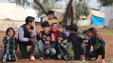 Aleppo, Syria, 10 December 2019: A group of refugee children play inside the camp clipart