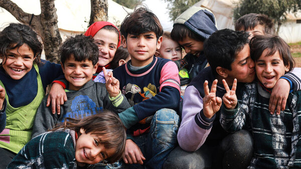 Aleppo, Syria, 10 December 2019: A group of refugee children play inside the camp