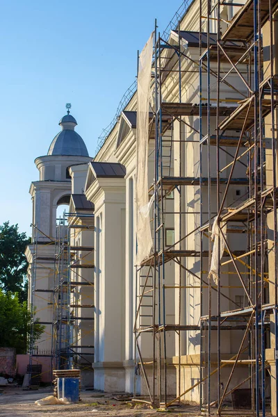 Scaffolding near a baroque monastery. Restoration of an architectural monument.