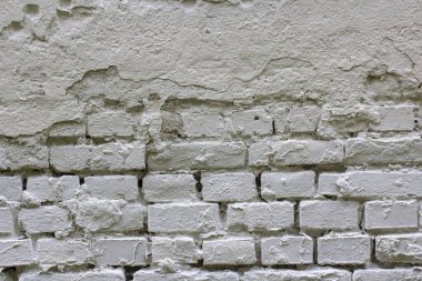 Kaba tuğla bir duvarın dokusu beyaza boyanmış. Metnin için yer.