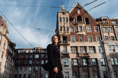 Genç fotoğrafçı, güzel günbatımının ve şapkanın eski fotoğraf makinesiyle fotoğraf çekimini yapıyor.