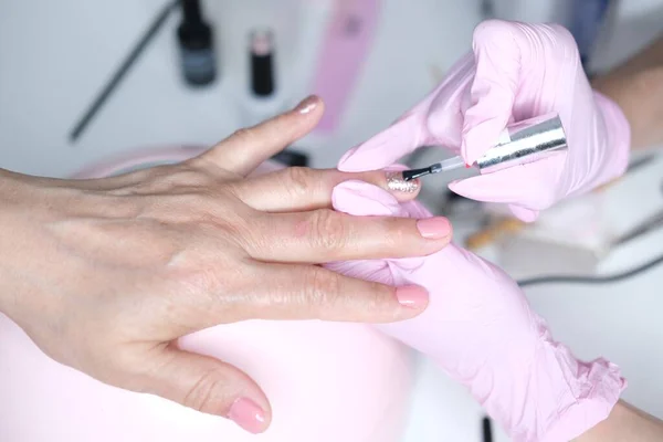 Professional nail care, manicure in a beauty salon. Nail design with colored gel polish — Stock Photo, Image
