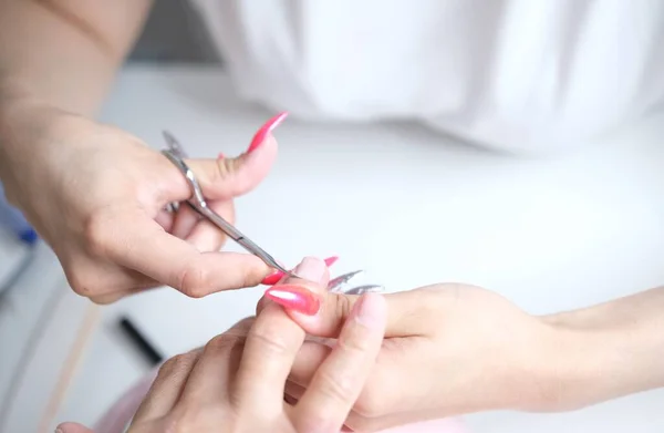 Cuticle removal with scissors. Nail care, Manicure in the salon — Stock Photo, Image