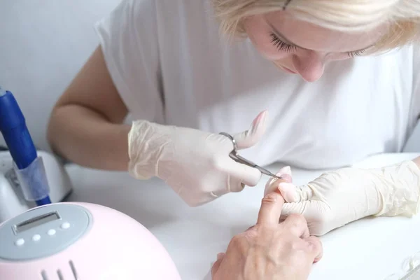 Nail care. Manicure in the salon. The master manicures the girl. Manicure process. — Stock Photo, Image