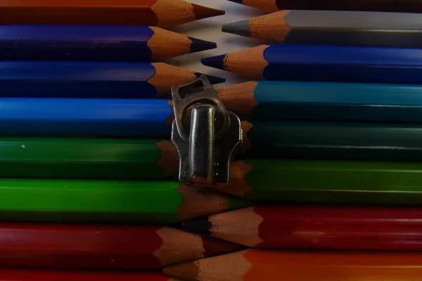 Colored pencils are lined up in a row