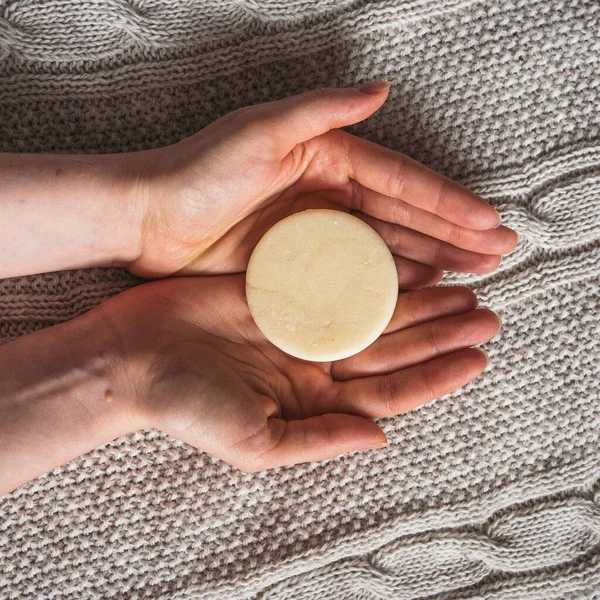 Female hands hold solid shampoo bar — Stock Photo, Image