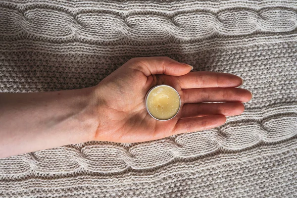 Lip balm in the female palm