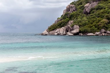 Tropikal deniz adaları manzaranın üstündedir. Beyaz kumlu plajı olan küçük bir tropikal ada. Mercan adasında güzel bir ada, yukarıdan manzaralı. Tropik deniz adası plaj manzarası. Ada sahnesi.