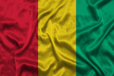 Kumaş dokusuna sahip Gine Cumhuriyeti ulusal bayrağı. Gine ve Barbuda bayrağı rüzgarda sallanıyor. 3B illüstrasyon.