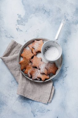 Ev yapımı yılbaşı yeni yıl yıldız şekli gingerbread çerezleri eski beton gri antika arka plan üzerinde seramik plaka. Üstten görünüm alanı ile.